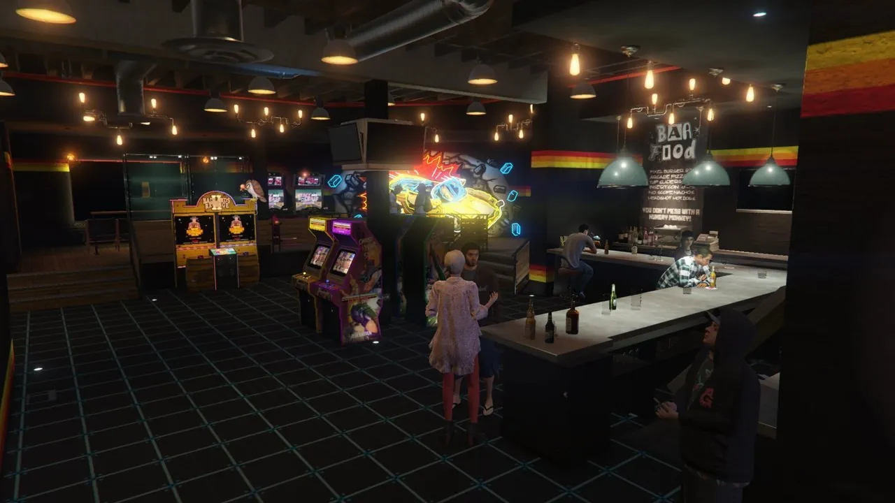 La salle d'arcade : machines, bar, écrans